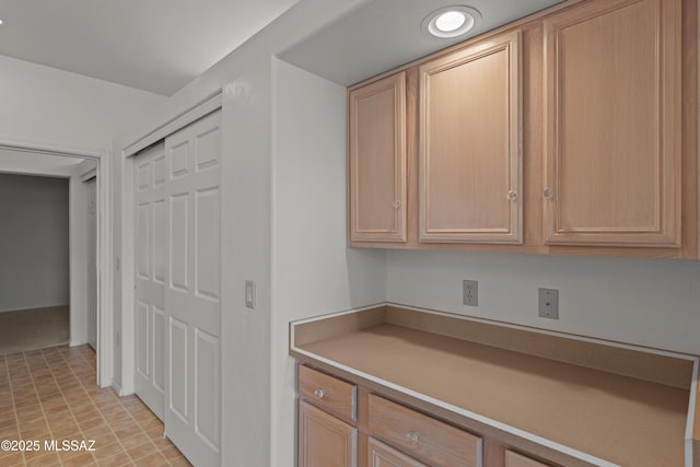 interior space with light countertops and light brown cabinets