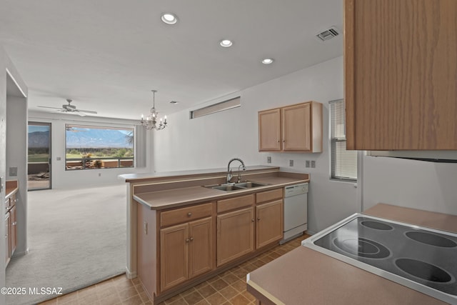 kitchen featuring visible vents, white dishwasher, a sink, a peninsula, and recessed lighting