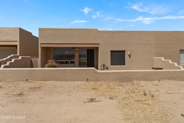 rear view of house with stucco siding