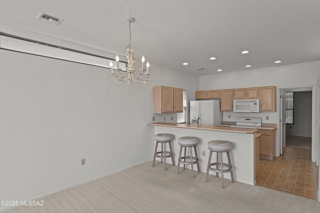 kitchen with white appliances, light colored carpet, visible vents, a breakfast bar, and a notable chandelier