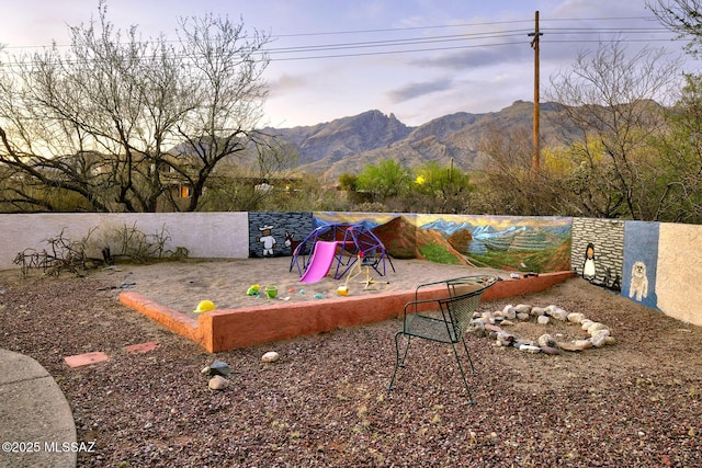 view of yard with a mountain view and fence