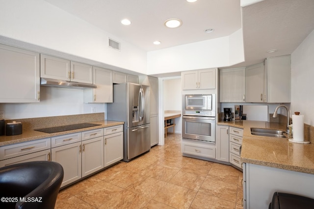 kitchen featuring gray cabinets, appliances with stainless steel finishes, a sink, and under cabinet range hood