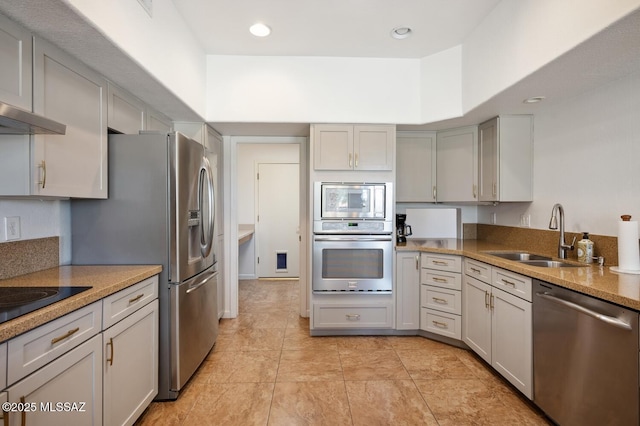 kitchen featuring light tile patterned floors, wall chimney exhaust hood, recessed lighting, a sink, and stainless steel appliances