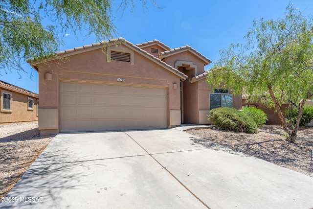 13140 E Mesquite Flat Spring Dr, Vail, AZ 85641 - view of front of house featuring stucco siding, a tiled roof, a garage, and driveway