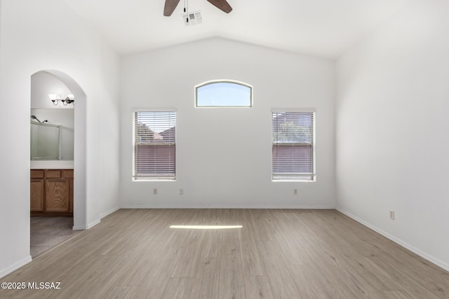 13140 E Mesquite Flat Spring Dr, Vail, AZ 85641 - unfurnished bedroom with light wood-style floors, lofted ceiling, baseboards, ensuite bathroom, and ceiling fan