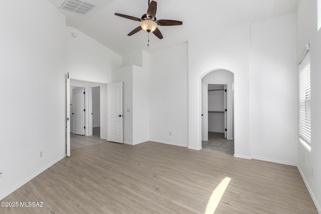 13140 E Mesquite Flat Spring Dr, Vail, AZ 85641 - unfurnished bedroom featuring arched walkways, high vaulted ceiling, light wood finished floors, baseboards, and a ceiling fan