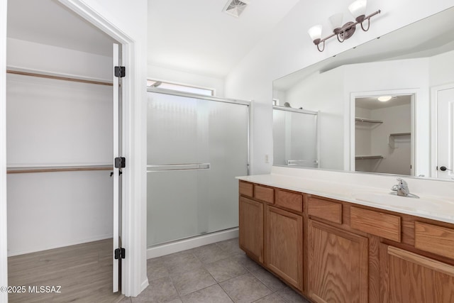 13140 E Mesquite Flat Spring Dr, Vail, AZ 85641 - bathroom featuring a stall shower, a walk in closet, and vanity