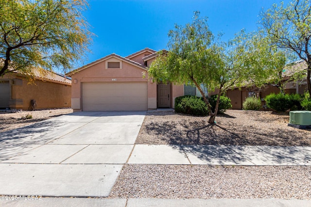 13140 E Mesquite Flat Spring Dr, Vail, AZ 85641 - view of front of house with stucco siding, an attached garage, driveway, central air condition unit, and a tiled roof