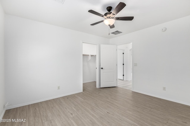 13140 E Mesquite Flat Spring Dr, Vail, AZ 85641 - unfurnished bedroom with light wood finished floors, baseboards, a spacious closet, and a closet