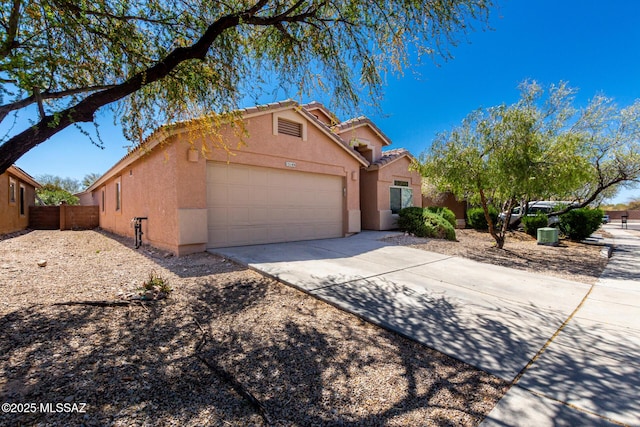 13140 E Mesquite Flat Spring Dr, Vail, AZ 85641 - view of front of home featuring an attached garage, stucco siding, concrete driveway, and fence