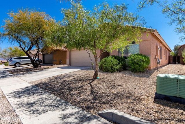 13140 E Mesquite Flat Spring Dr, Vail, AZ 85641 - obstructed view of property featuring stucco siding, concrete driveway, a garage, and a tiled roof