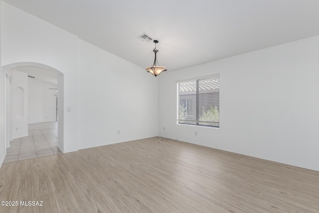 13140 E Mesquite Flat Spring Dr, Vail, AZ 85641 - unfurnished room with arched walkways and light wood-style flooring