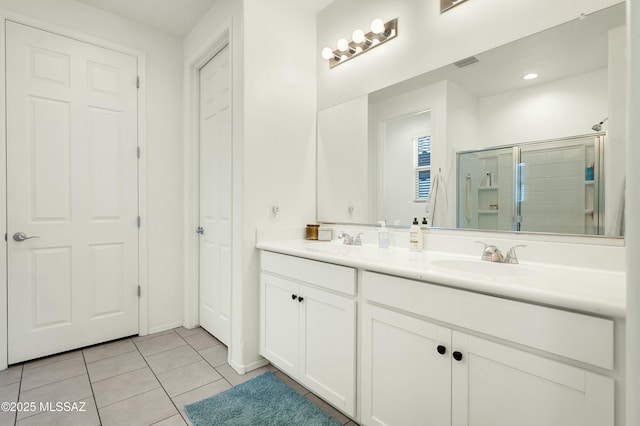 6548 E Via Arroyo Largo, Tucson, AZ 85756 - bathroom with double vanity, a shower stall, and tile patterned floors
