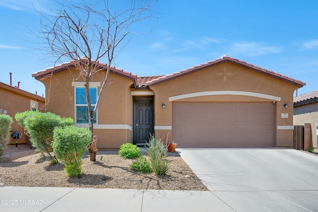6548 E Via Arroyo Largo, Tucson, AZ 85756 - view of front facade with stucco siding, an attached garage, concrete driveway, and a tiled roof