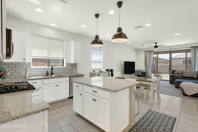 6548 E Via Arroyo Largo, Tucson, AZ 85756 - kitchen with open floor plan, a sink, stainless steel dishwasher, decorative backsplash, and light tile patterned flooring