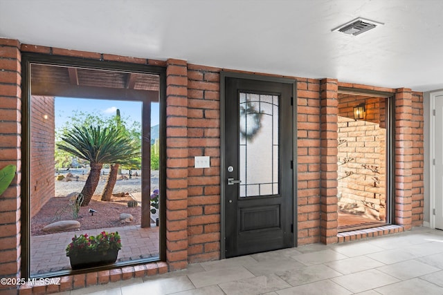 foyer with visible vents and tile patterned flooring