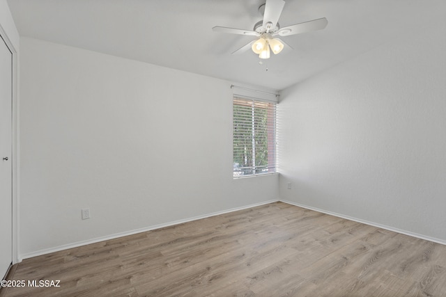 spare room with ceiling fan, wood finished floors, and baseboards