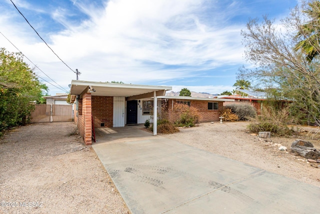 423 E Hadley St, Tucson, AZ 85705 - ranch-style home featuring concrete driveway, brick siding, fence, and a carport