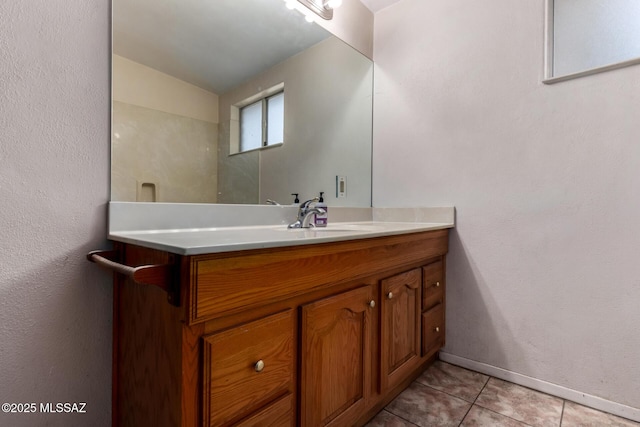 423 E Hadley St, Tucson, AZ 85705 - bathroom featuring tile patterned floors, baseboards, and vanity