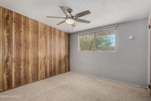 423 E Hadley St, Tucson, AZ 85705 - carpeted empty room with ceiling fan and wooden walls