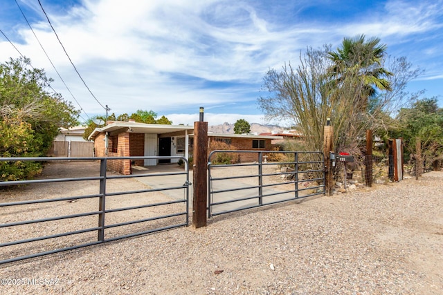 423 E Hadley St, Tucson, AZ 85705 - view of front facade with driveway, brick siding, and an exterior structure