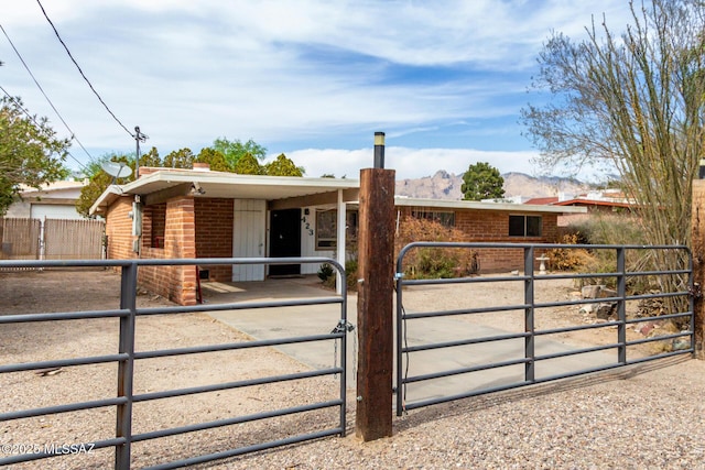 423 E Hadley St, Tucson, AZ 85705 - view of front of property with brick siding, an outbuilding, a mountain view, and an exterior structure