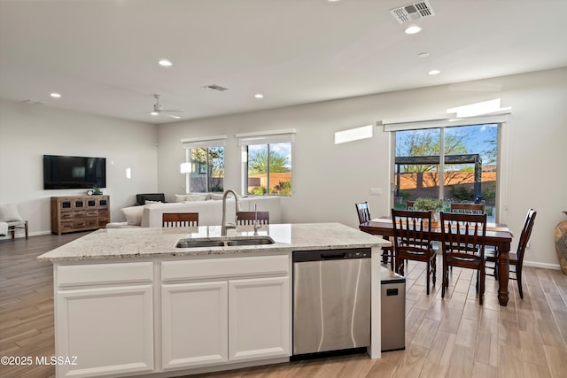 7797 S Indian Wheat Way, Tucson, AZ 85747 - kitchen with stainless steel dishwasher, a sink, open floor plan, recessed lighting, and plenty of natural light