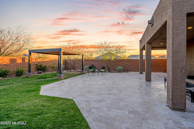 7797 S Indian Wheat Way, Tucson, AZ 85747 - patio terrace at dusk featuring a patio area