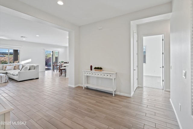 7797 S Indian Wheat Way, Tucson, AZ 85747 - corridor featuring baseboards, light wood finished floors, and recessed lighting