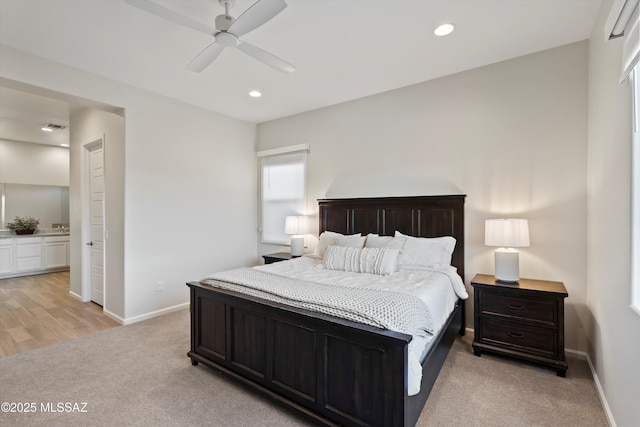 7797 S Indian Wheat Way, Tucson, AZ 85747 - bedroom with light carpet, baseboards, recessed lighting, ceiling fan, and ensuite bathroom