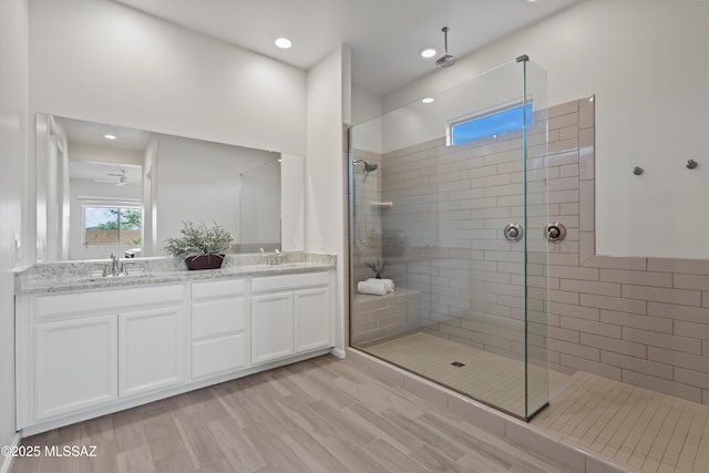 7797 S Indian Wheat Way, Tucson, AZ 85747 - bathroom with double vanity, walk in shower, recessed lighting, and wood finished floors