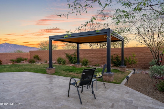 7797 S Indian Wheat Way, Tucson, AZ 85747 - patio terrace at dusk featuring a gazebo, a patio, and a mountain view