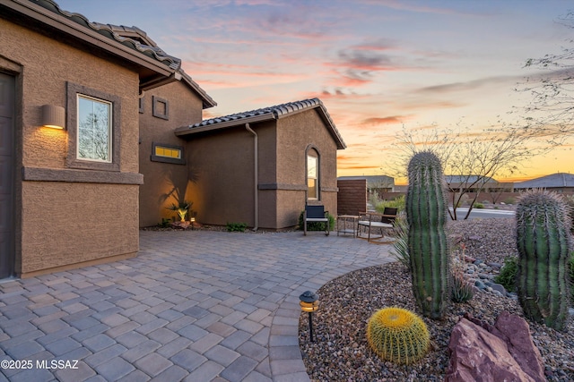 7797 S Indian Wheat Way, Tucson, AZ 85747 - patio terrace at dusk with a patio area