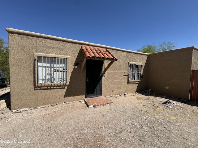 view of front of home with a tile roof and stucco siding