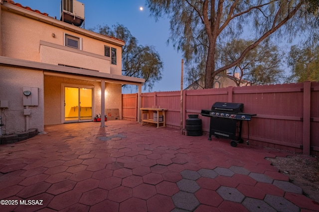 view of patio featuring a fenced backyard and a grill