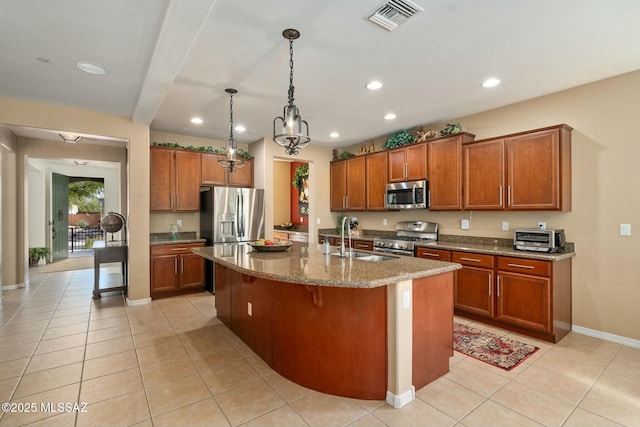 12487 N Wind Runner Pkwy, Marana, AZ 85658 - kitchen with stainless steel appliances, a sink, brown cabinets, light tile patterned floors, and recessed lighting