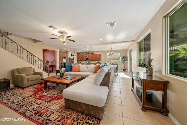 12487 N Wind Runner Pkwy, Marana, AZ 85658 - living room featuring light tile patterned floors, a ceiling fan, and baseboards