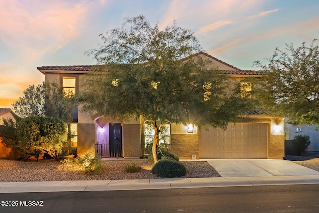 12487 N Wind Runner Pkwy, Marana, AZ 85658 - view of front of home with concrete driveway, stucco siding, a tile roof, and an attached garage