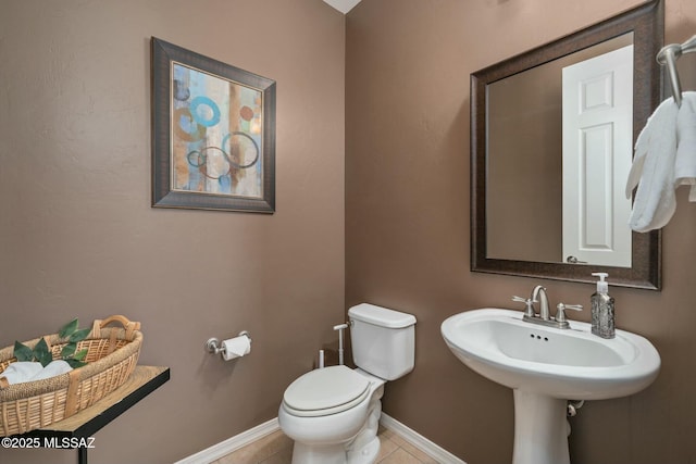 12487 N Wind Runner Pkwy, Marana, AZ 85658 - half bathroom featuring baseboards, toilet, and tile patterned flooring