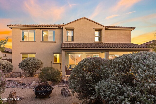 12487 N Wind Runner Pkwy, Marana, AZ 85658 - view of front of house featuring a fire pit, stucco siding, and a tiled roof