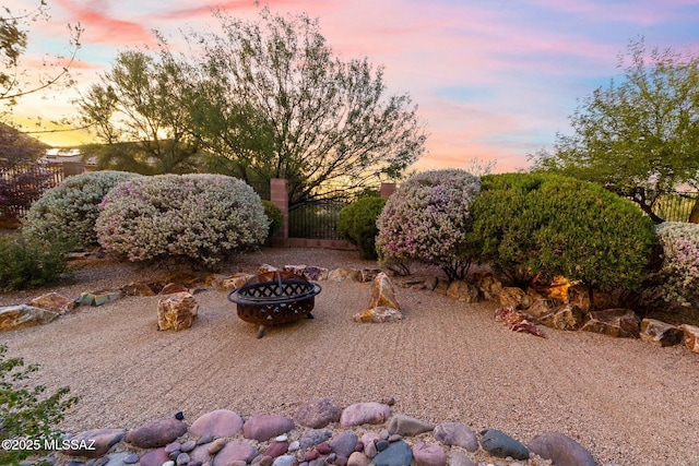12487 N Wind Runner Pkwy, Marana, AZ 85658 - yard at dusk featuring a fire pit
