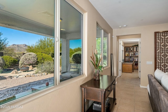 12487 N Wind Runner Pkwy, Marana, AZ 85658 - hallway featuring tile patterned flooring, baseboards, and a mountain view
