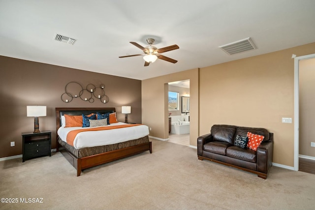 12487 N Wind Runner Pkwy, Marana, AZ 85658 - carpeted bedroom with baseboards, ensuite bathroom, and a ceiling fan
