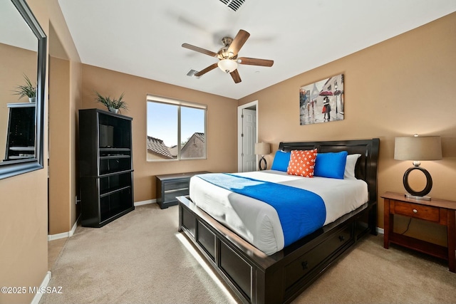 12487 N Wind Runner Pkwy, Marana, AZ 85658 - bedroom featuring baseboards, light colored carpet, and ceiling fan