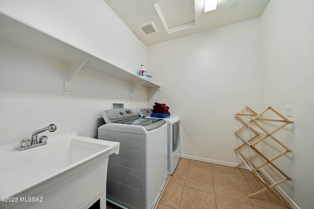 12487 N Wind Runner Pkwy, Marana, AZ 85658 - laundry room featuring washing machine and dryer, light tile patterned floors, and baseboards