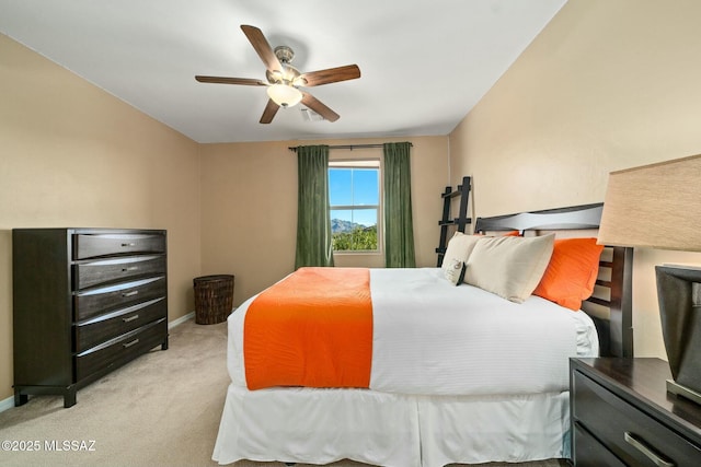 12487 N Wind Runner Pkwy, Marana, AZ 85658 - bedroom featuring light colored carpet, a ceiling fan, and baseboards