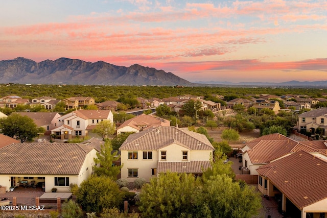 12487 N Wind Runner Pkwy, Marana, AZ 85658 - aerial view at dusk of a residential view and a mountain view