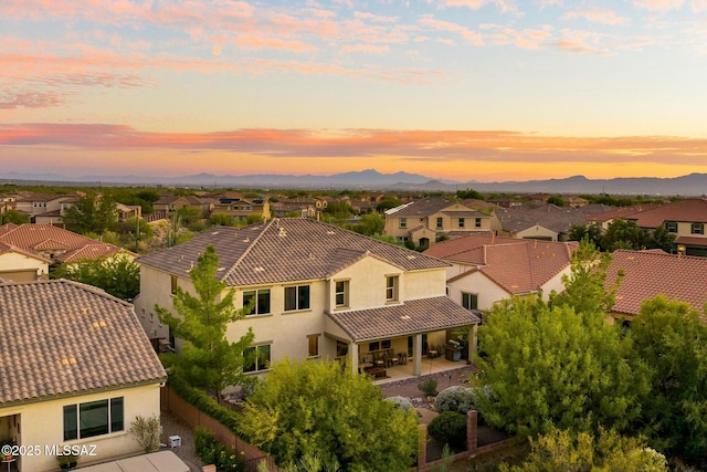 12487 N Wind Runner Pkwy, Marana, AZ 85658 - aerial view at dusk of a residential view and a mountain view