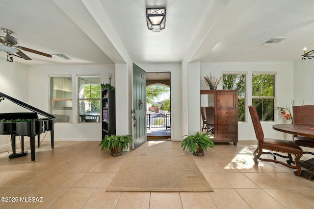12487 N Wind Runner Pkwy, Marana, AZ 85658 - foyer entrance featuring light tile patterned flooring, ceiling fan, and baseboards
