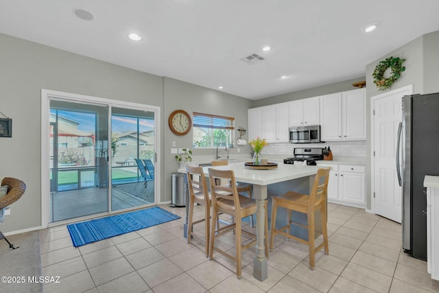10391 E Malta St, Tucson, AZ 85747 - kitchen with white cabinets, appliances with stainless steel finishes, a sink, light countertops, and visible vents